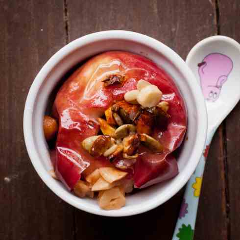 Baked apples with fruits and nuts.