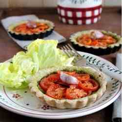 Whole tomatoes and pesto tartlets with van