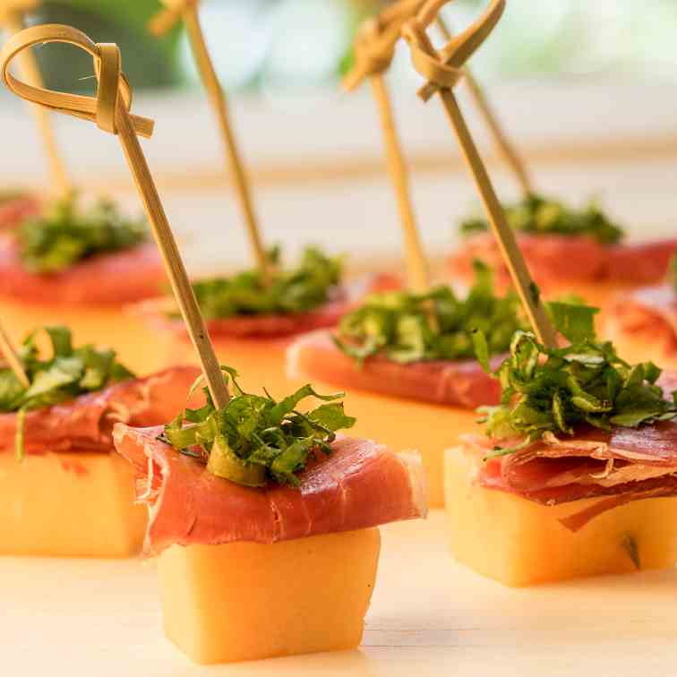 Melon - Prosciutto Skewers over Greens Mix