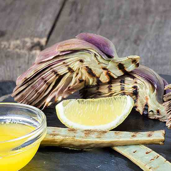 Grilled artichokes and stems with lemon bu