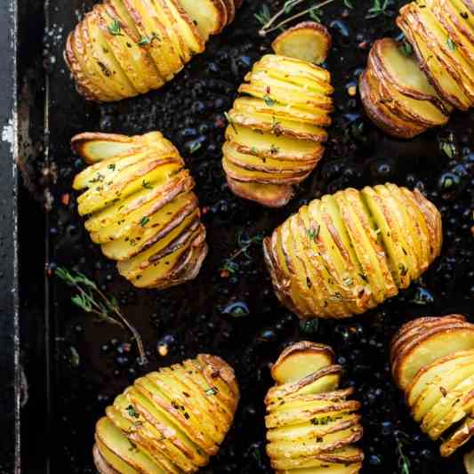 Vegan hasselback potatoes in herby oil