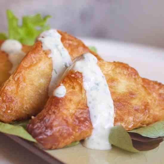 Puff pastry samosas with mint yogurt sauce