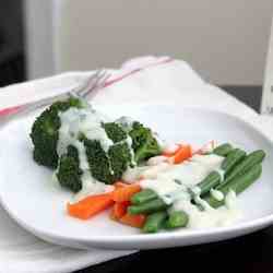 White sauce served with steamed vegetables