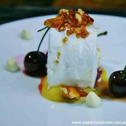 Soft Pavlova Roll with poached Cherries 