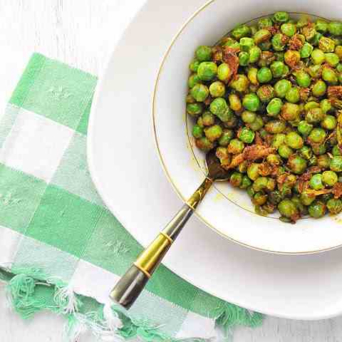 Quick curried peas. Butter is involved.