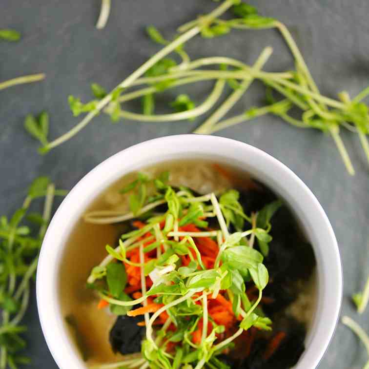 Vegan miso soup with rice, carrots, and pe