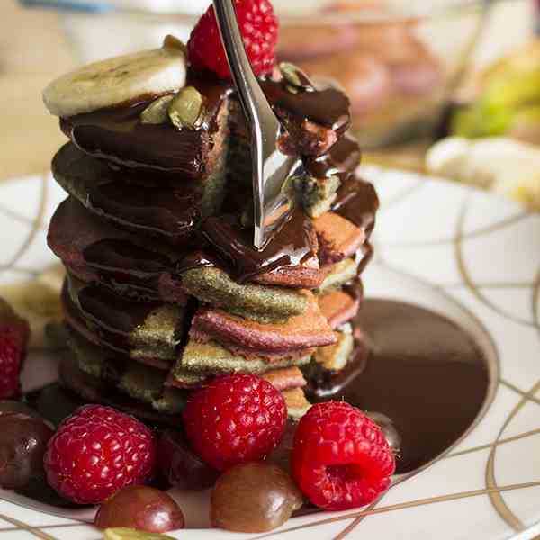 Colorful pancakes with chocolate sauce
